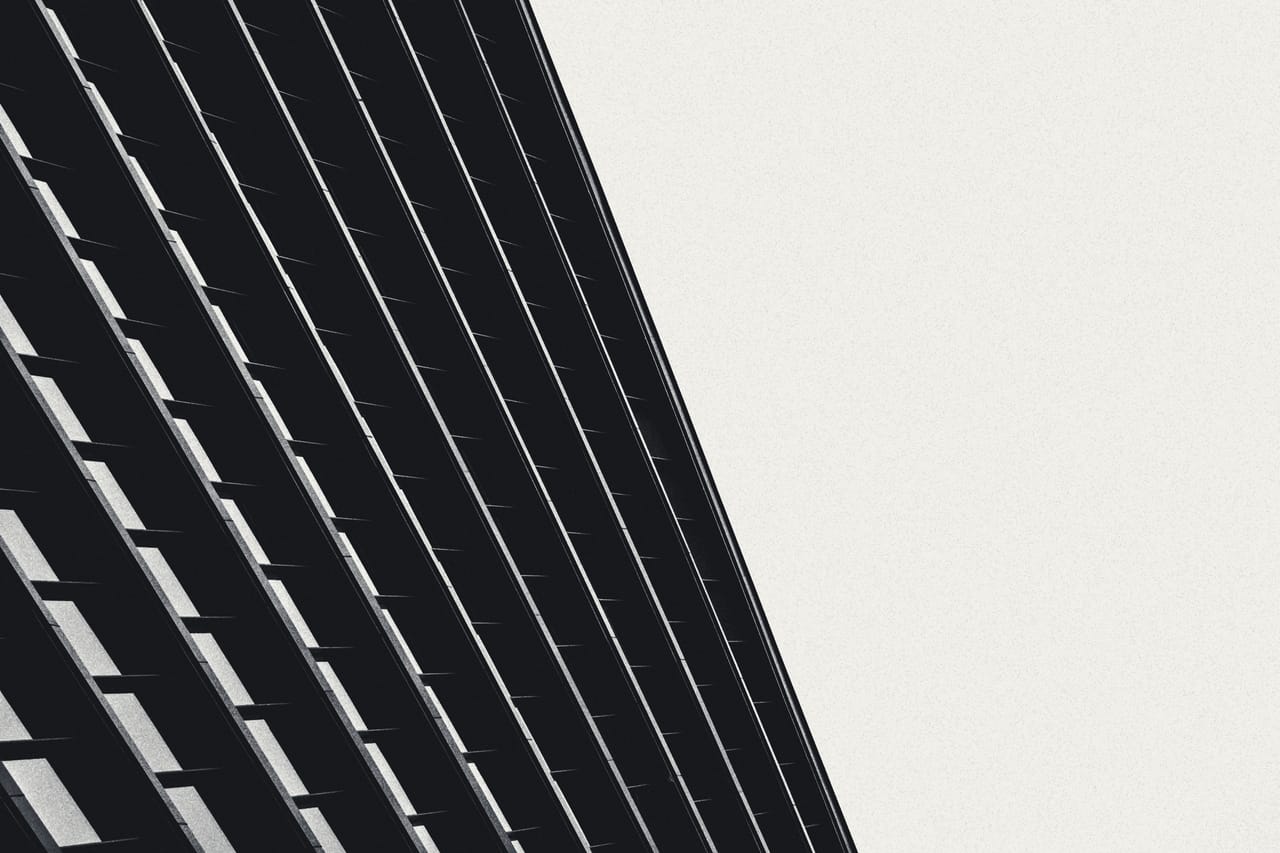 Diagonal facade grid cutting across a blank sky
